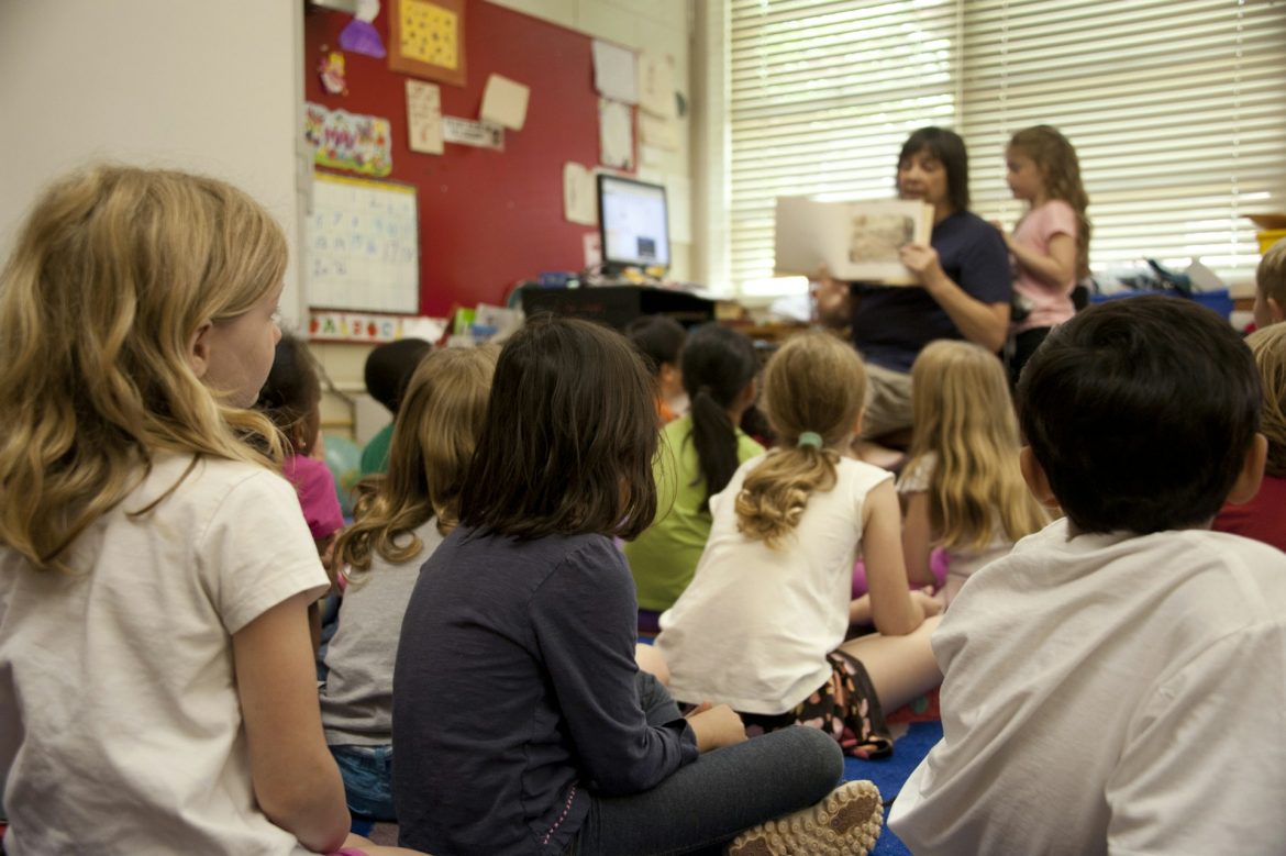 A teacher is teaching in a kindergarten class